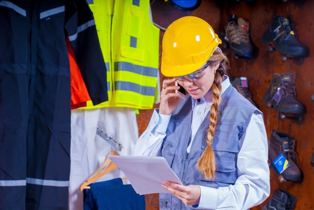 woman in  safety equipment making phone call